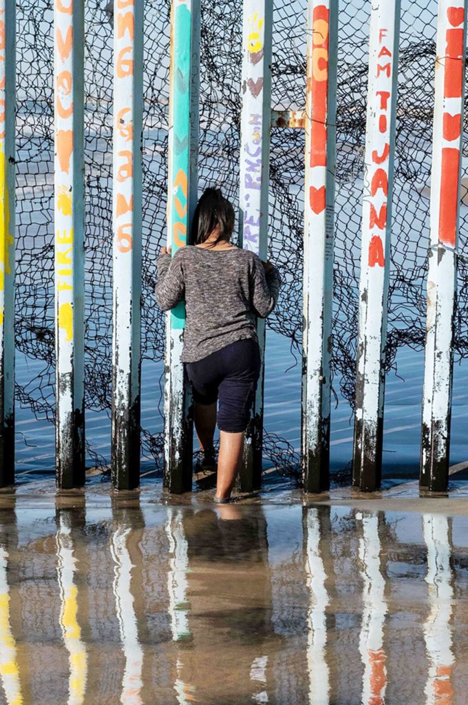 A girl from Salvador looks through the US-Mexico border fence in Playas de Tijuana, Baja California State, Mexico, on December 29, 2018. Guillermo Arias/AFP via Getty Image