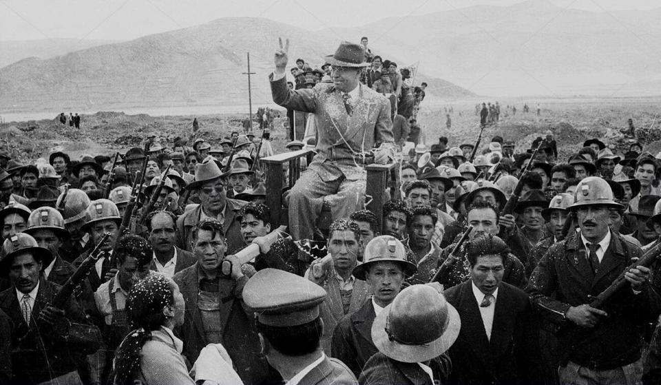 Armed miners carry Bolivian former President Víctor Paz Estenssoro in a chair on a visit to the mine of Catavi in Central Bolivia, 1959